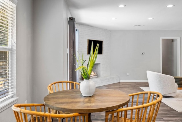 dining area with dark wood finished floors, recessed lighting, a fireplace, and baseboards