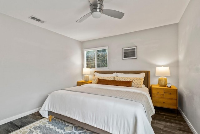 bedroom featuring visible vents, baseboards, wood finished floors, and a ceiling fan