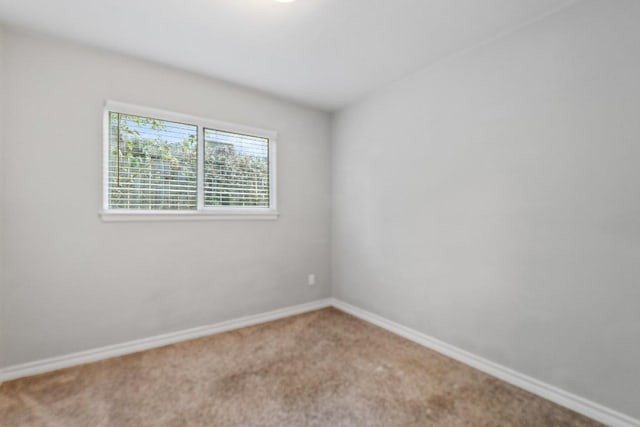 unfurnished room featuring baseboards and carpet flooring