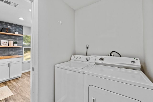 laundry room with visible vents, light wood finished floors, laundry area, recessed lighting, and washing machine and dryer