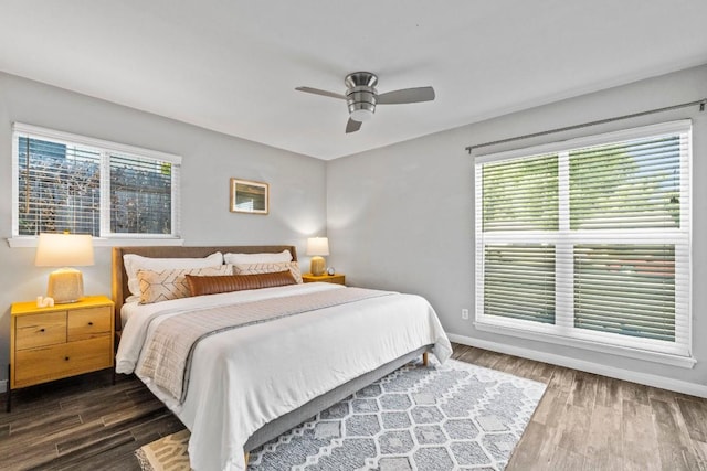 bedroom featuring dark wood finished floors, ceiling fan, and baseboards