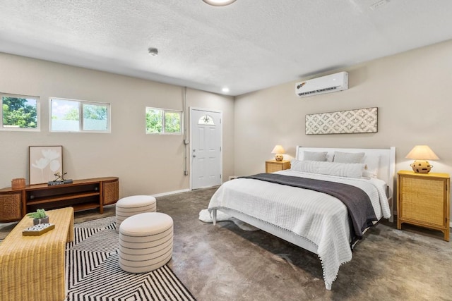 bedroom featuring baseboards, a textured ceiling, an AC wall unit, and carpet