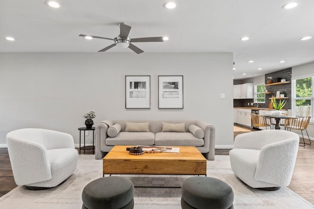 living room with recessed lighting, light wood-type flooring, baseboards, and ceiling fan