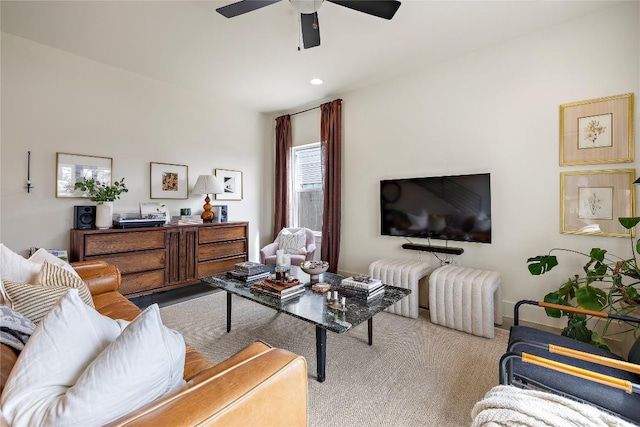 living area with carpet floors and a ceiling fan