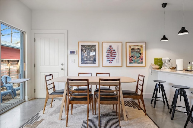 dining space with concrete flooring