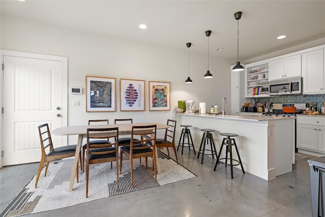 dining area featuring recessed lighting and concrete flooring