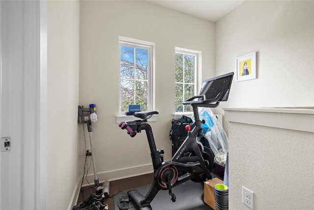 workout room featuring baseboards