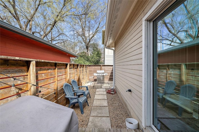 view of patio / terrace with area for grilling and fence