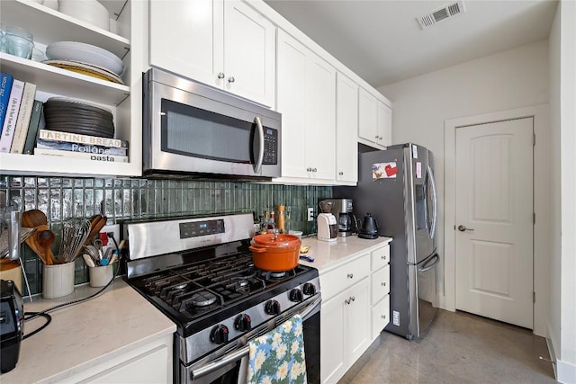 kitchen featuring stainless steel appliances, visible vents, decorative backsplash, and white cabinetry