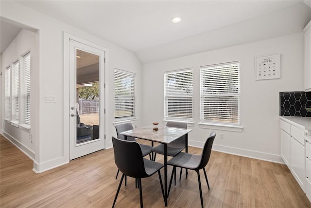 dining room featuring lofted ceiling, recessed lighting, baseboards, and light wood-type flooring