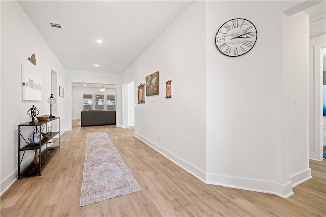 hall featuring recessed lighting, baseboards, visible vents, and light wood-type flooring