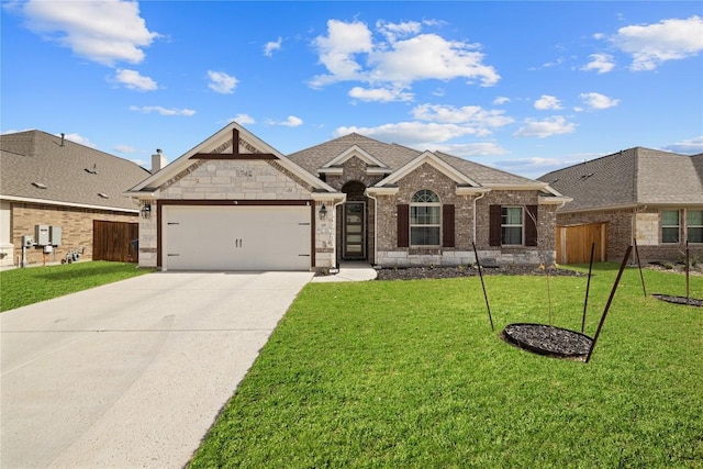 view of front of property with a front yard, fence, an attached garage, concrete driveway, and brick siding