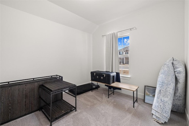 sitting room with vaulted ceiling, carpet flooring, and baseboards