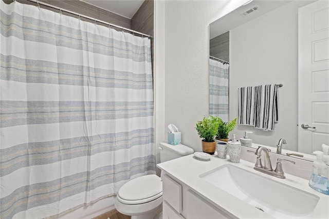 full bathroom with vanity, curtained shower, toilet, and visible vents