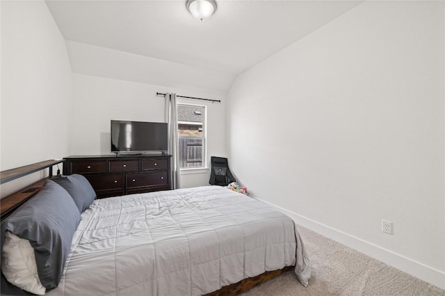 bedroom with baseboards, carpet, and vaulted ceiling