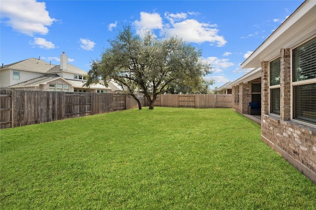 view of yard with a fenced backyard