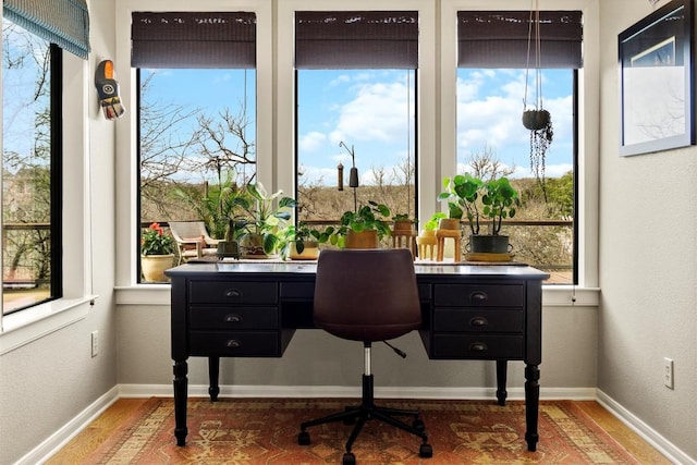 office featuring wood finished floors, baseboards, and a textured wall