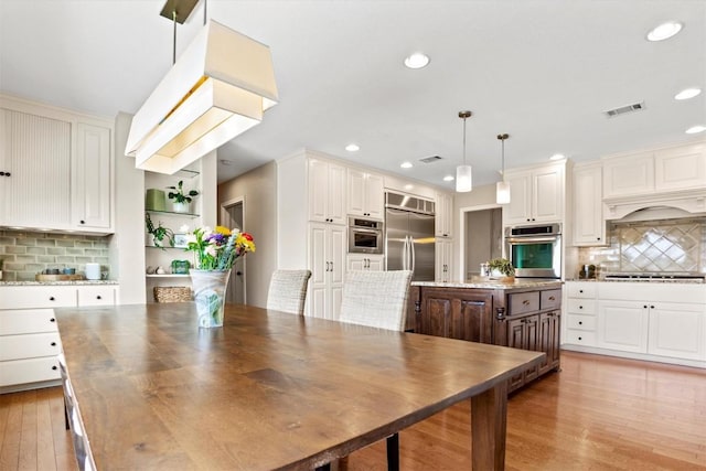 dining space with recessed lighting, visible vents, and light wood-type flooring