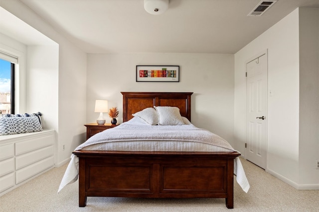 bedroom with visible vents, baseboards, and light colored carpet