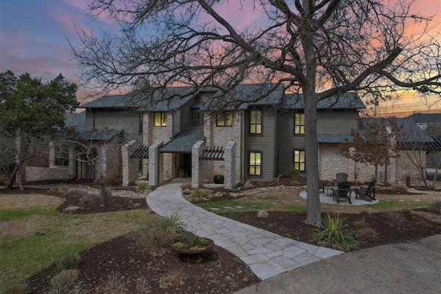 view of front of house featuring a patio area and stone siding