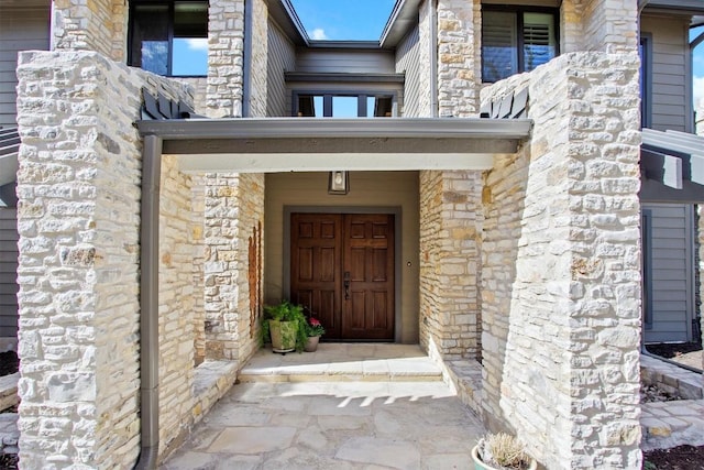 entrance to property featuring stone siding