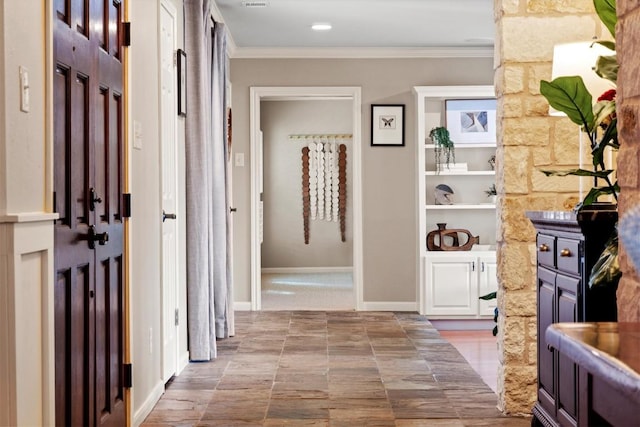 hallway with baseboards and crown molding