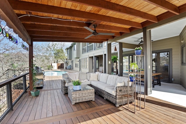 wooden terrace featuring an outdoor pool, an outdoor hangout area, and ceiling fan