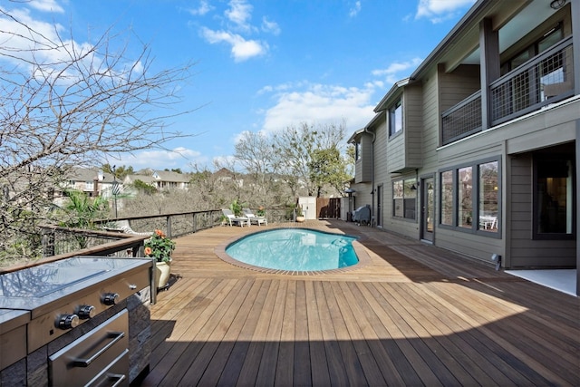 view of pool with a fenced in pool and a wooden deck