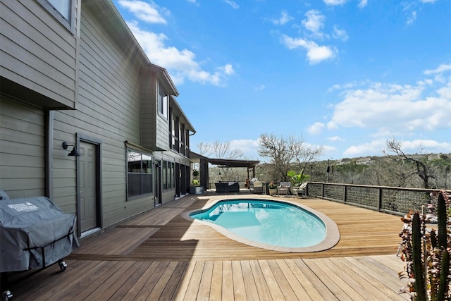 view of pool with an outdoor living space, a fenced in pool, area for grilling, and a deck