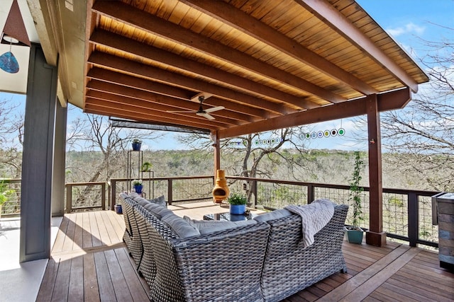 wooden terrace featuring an outdoor living space and ceiling fan