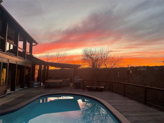 view of swimming pool featuring a fenced in pool, a wooden deck, and a patio area