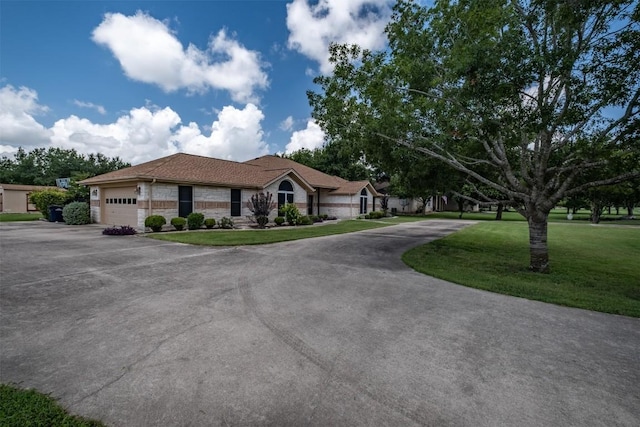 194 Brushy Creek Trl, Hutto, TX 78634 - single story home with asphalt driveway, an attached garage, a front yard, and stone siding