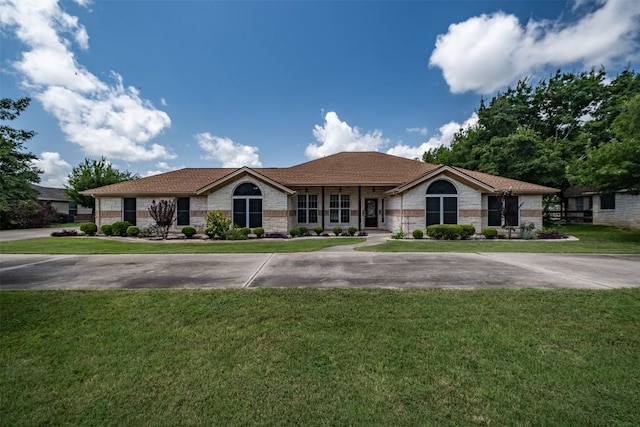 194 Brushy Creek Trl, Hutto, TX 78634 - single story home featuring stone siding and a front lawn