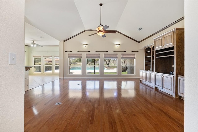 194 Brushy Creek Trl, Hutto, TX 78634 - unfurnished living room featuring a ceiling fan, healthy amount of natural light, wood finished floors, and high vaulted ceiling