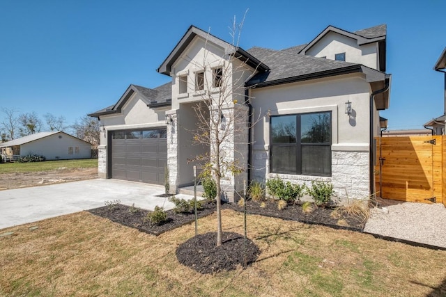 view of front of home with stucco siding, stone siding, concrete driveway, an attached garage, and a shingled roof