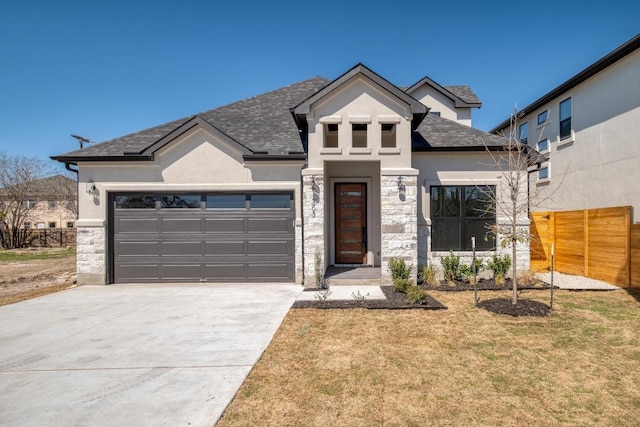 view of front of house featuring a garage, stone siding, stucco siding, and fence