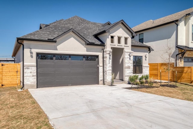 view of front of property with fence, concrete driveway, stucco siding, a garage, and stone siding