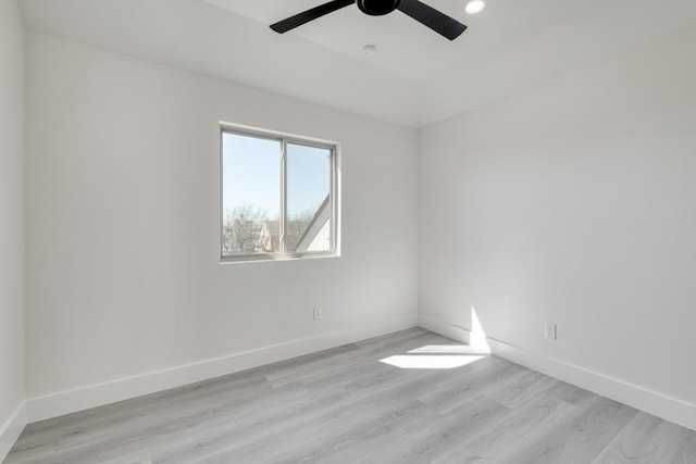 unfurnished room with recessed lighting, light wood-style flooring, a ceiling fan, and baseboards