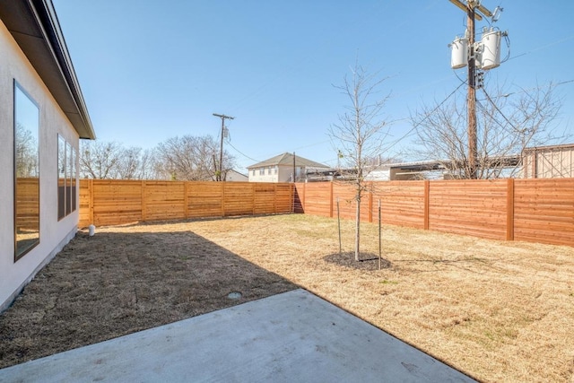 view of yard featuring a patio area and a fenced backyard