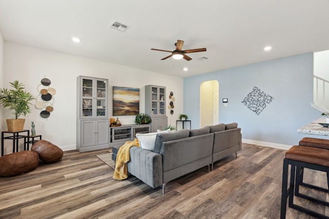 1429 Freer Cv, Leander, TX 78641 - living area featuring arched walkways, wood finished floors, a ceiling fan, and recessed lighting