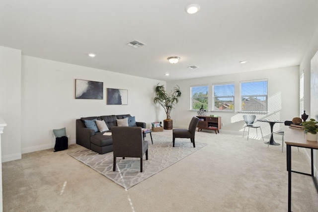 carpeted living room featuring recessed lighting, visible vents, and baseboards