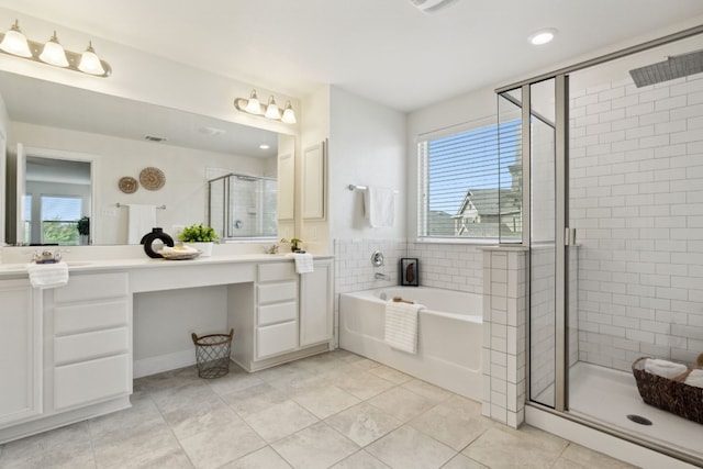 1429 Freer Cv, Leander, TX 78641 - bathroom with double vanity, a stall shower, a bath, healthy amount of natural light, and recessed lighting