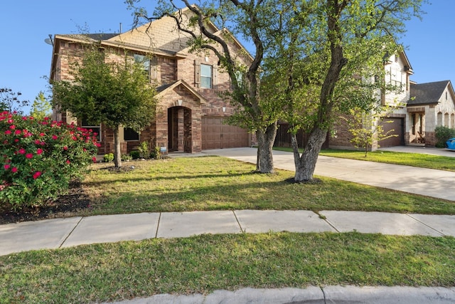 1429 Freer Cv, Leander, TX 78641 - view of front of property featuring a garage, concrete driveway, brick siding, and a front lawn