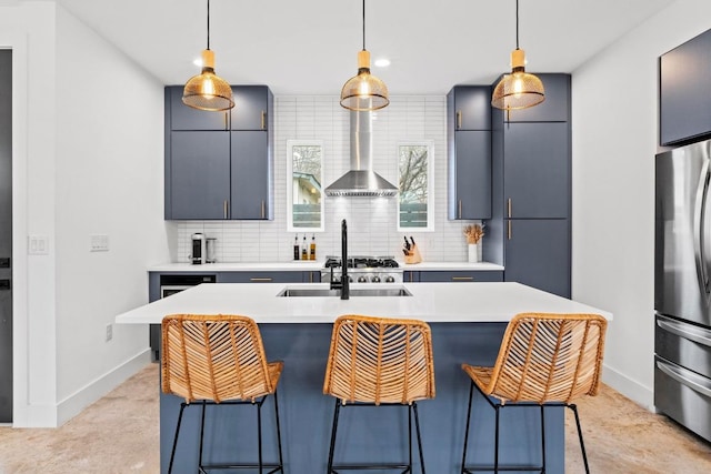 kitchen featuring tasteful backsplash, pendant lighting, light countertops, and freestanding refrigerator