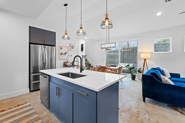 kitchen featuring a sink, open floor plan, appliances with stainless steel finishes, light countertops, and lofted ceiling