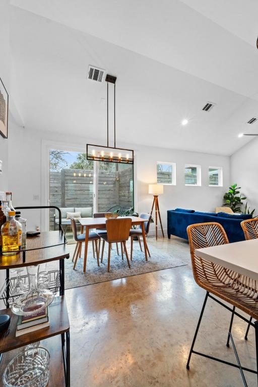 dining room with a wealth of natural light, visible vents, and concrete floors