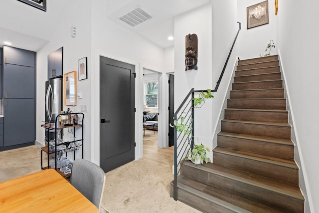 staircase featuring recessed lighting, visible vents, and carpet