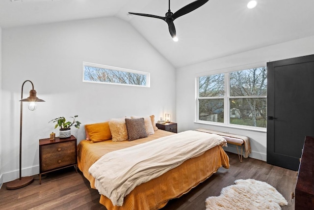 bedroom with vaulted ceiling, multiple windows, and wood finished floors