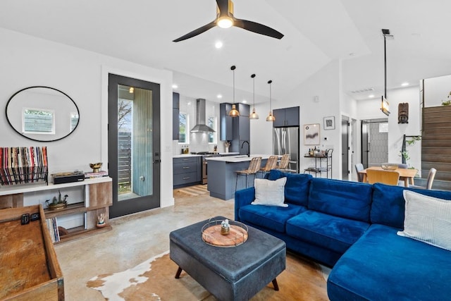 living room featuring concrete floors, stairs, vaulted ceiling, recessed lighting, and a ceiling fan