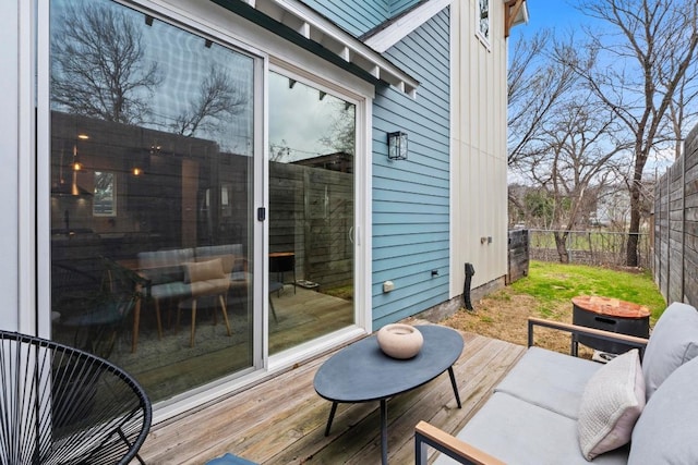 wooden terrace featuring outdoor lounge area and fence